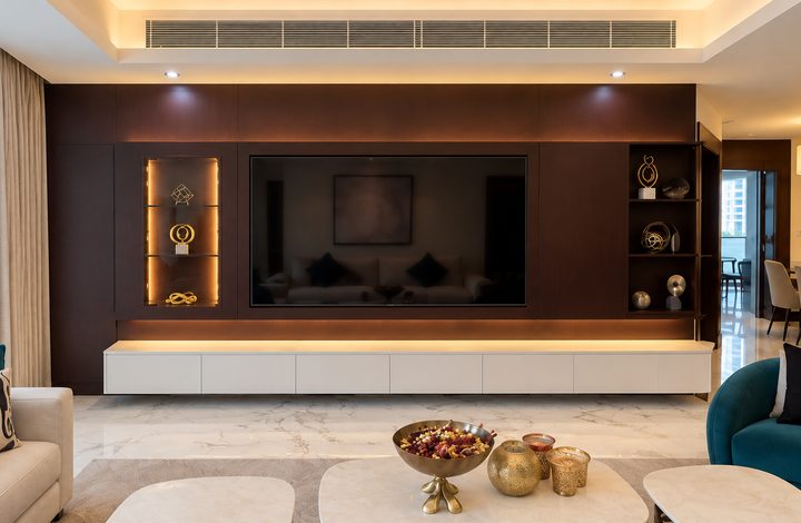 Dark timber media wall with integrated television and lit display niches
